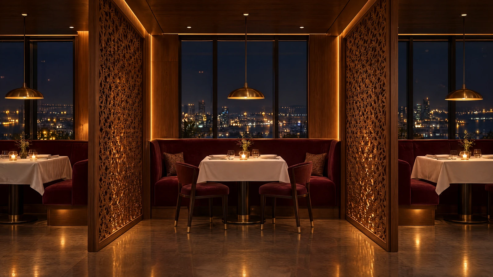 Pavilion, the fine-dining room: private tables between walnut jali screens, burgundy banquettes