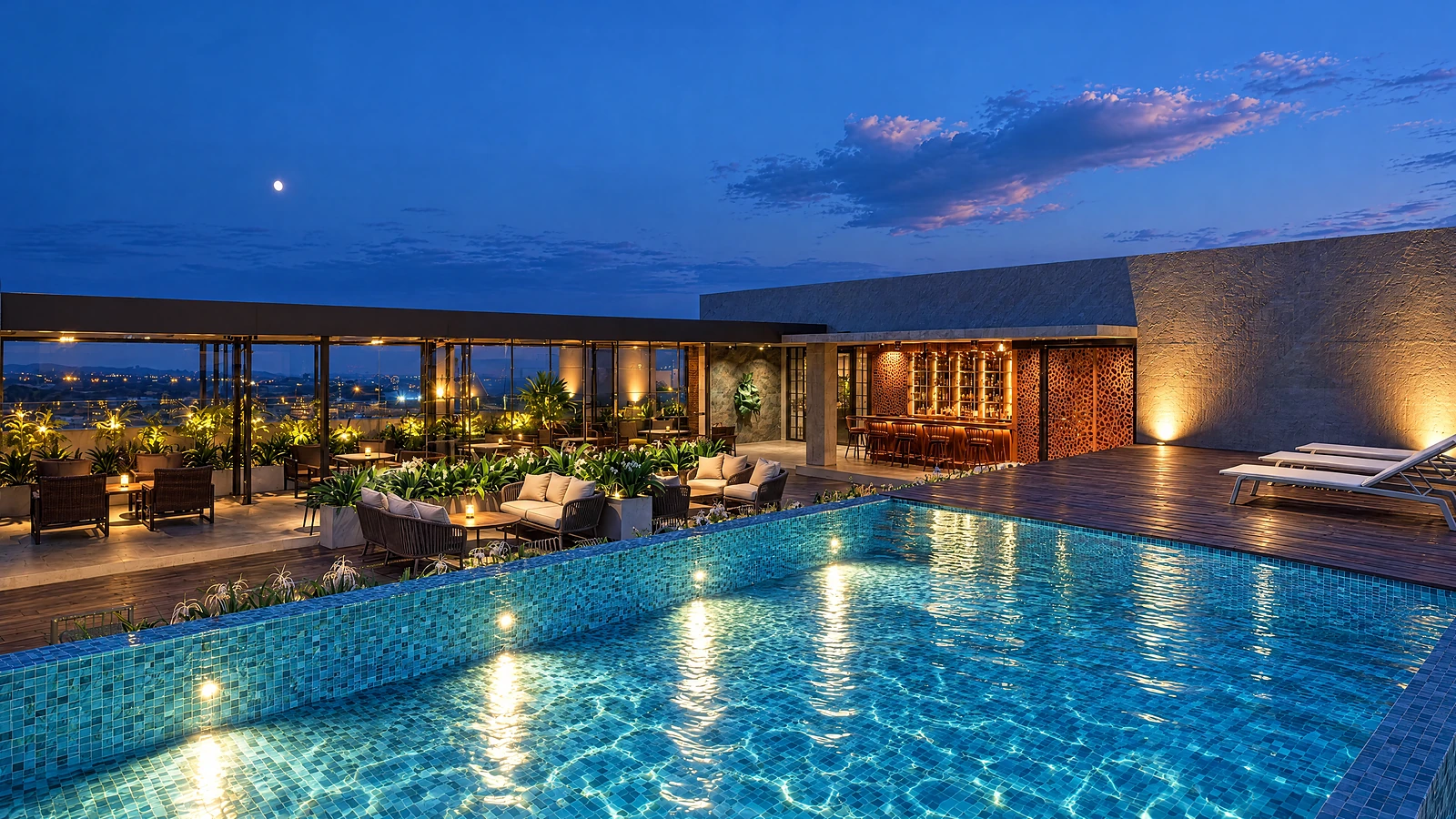 The infinity pool at Crown lit at night, the bar and lounge behind