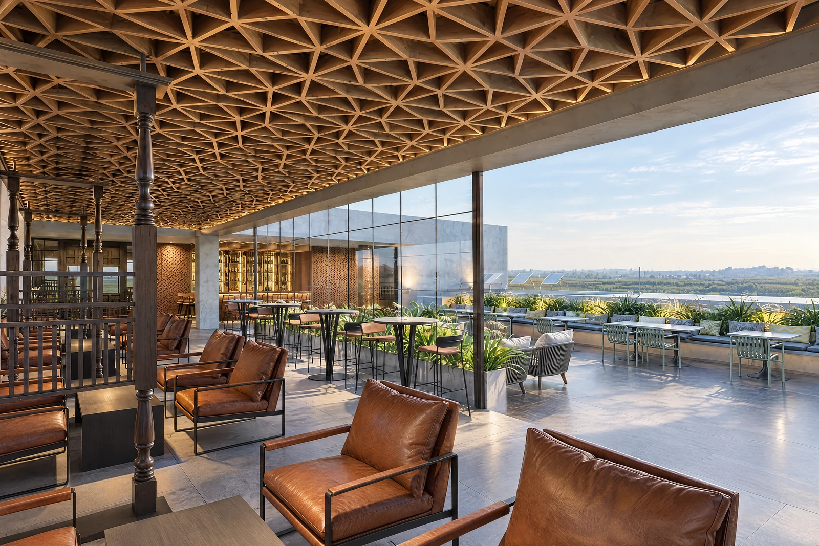 The rooftop terrace at Garnet by day, with lattice ceiling and leather chairs facing the valley